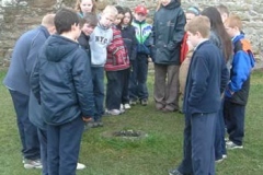 Pupils around Bullaun Stone in Clonmacnois